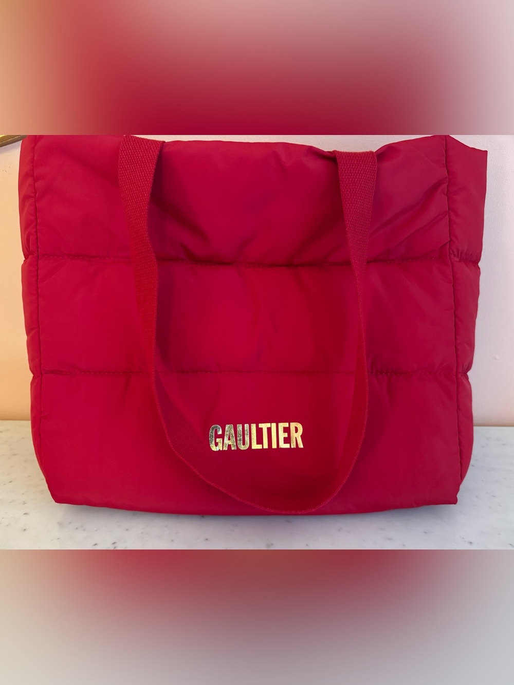 Gaultier Bright Red Puffy Tote Bag with Gold Script. Open Top.